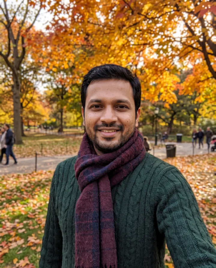 AI autumn portrait of the same man in a green sweater and scarf in a park full of orange leaves