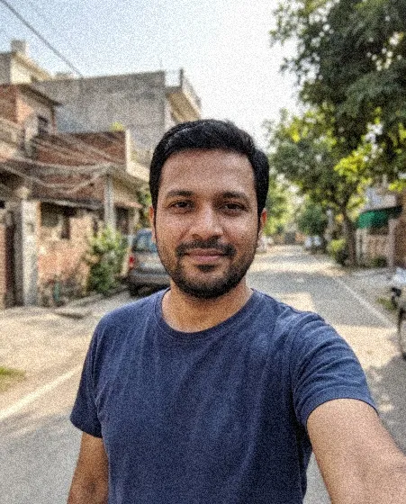 A small, grainy copy of a selfie (an AI-generated person)